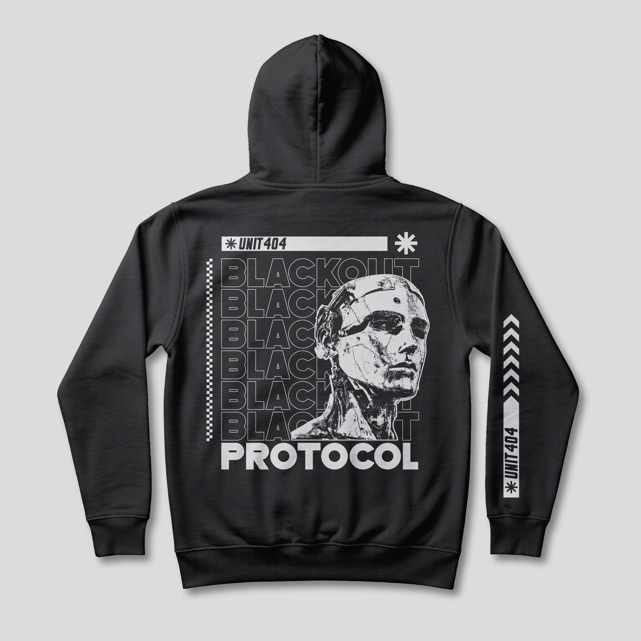 Back of a black hoodie with a fragmented white face over repeated Blackout typography, a UNIT 404 stamp and an arrow graphic down the sleeve
