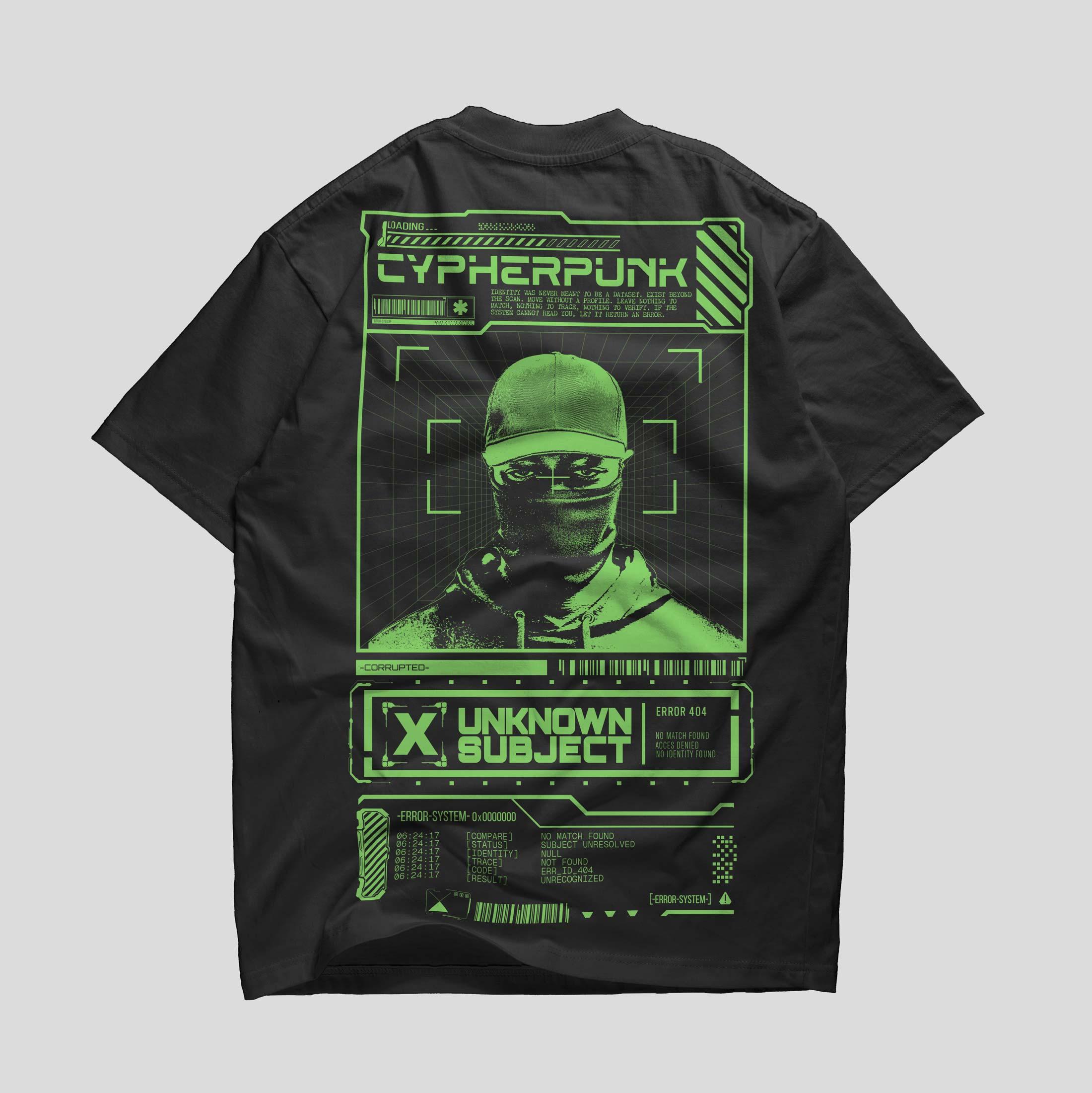 Back of a black T-shirt with green Unknown Subject artwork, a masked figure, Cypherpunk lettering and surveillance-style graphics